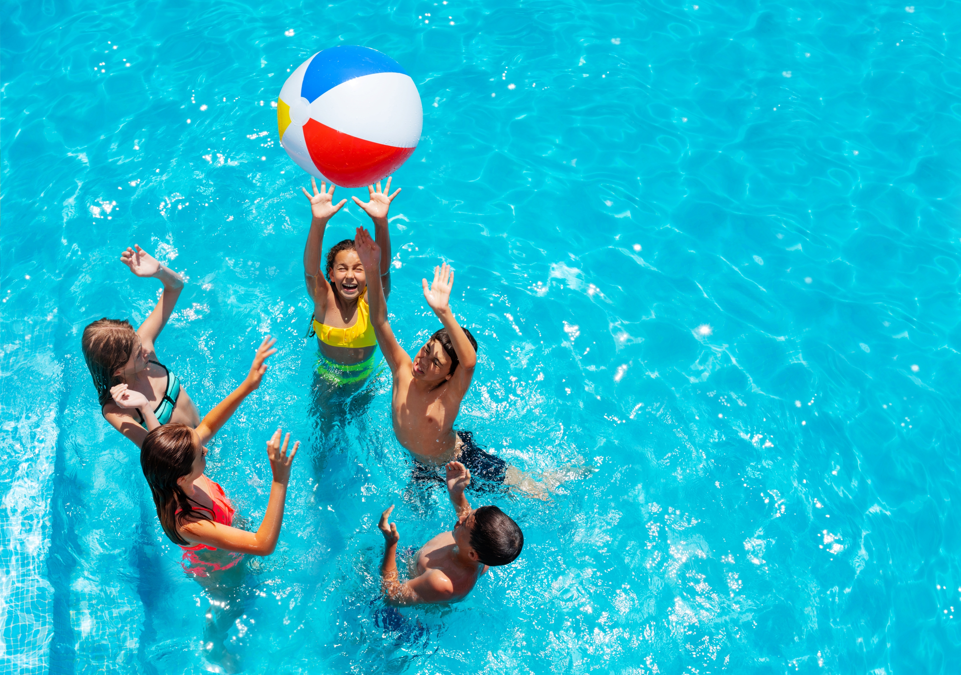 A group playing with a pool ball