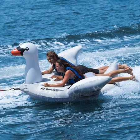 Kids Being Towed On Lay-On Towable Inflatable Swan