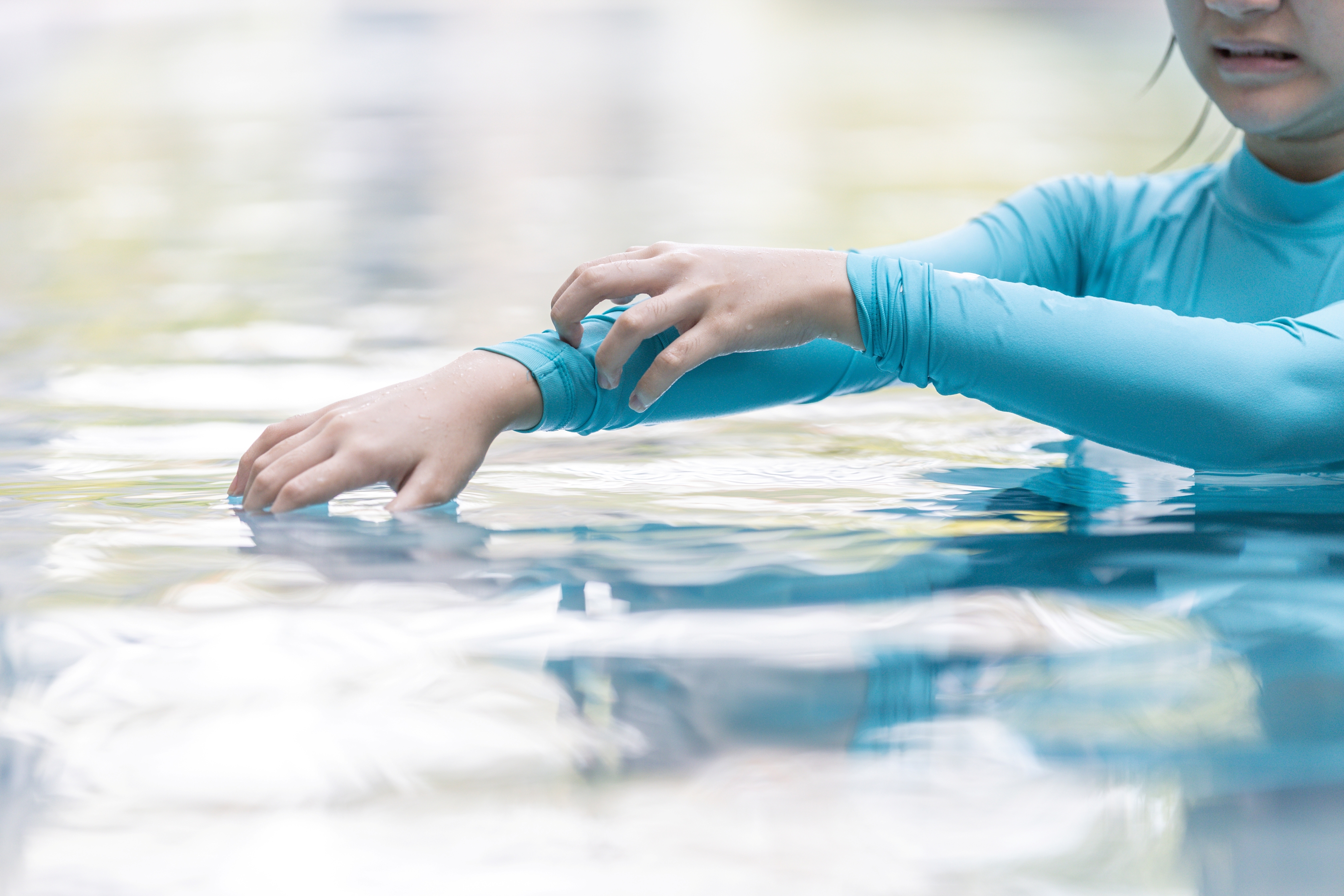 a woman irritated by a pool having too much chlorine