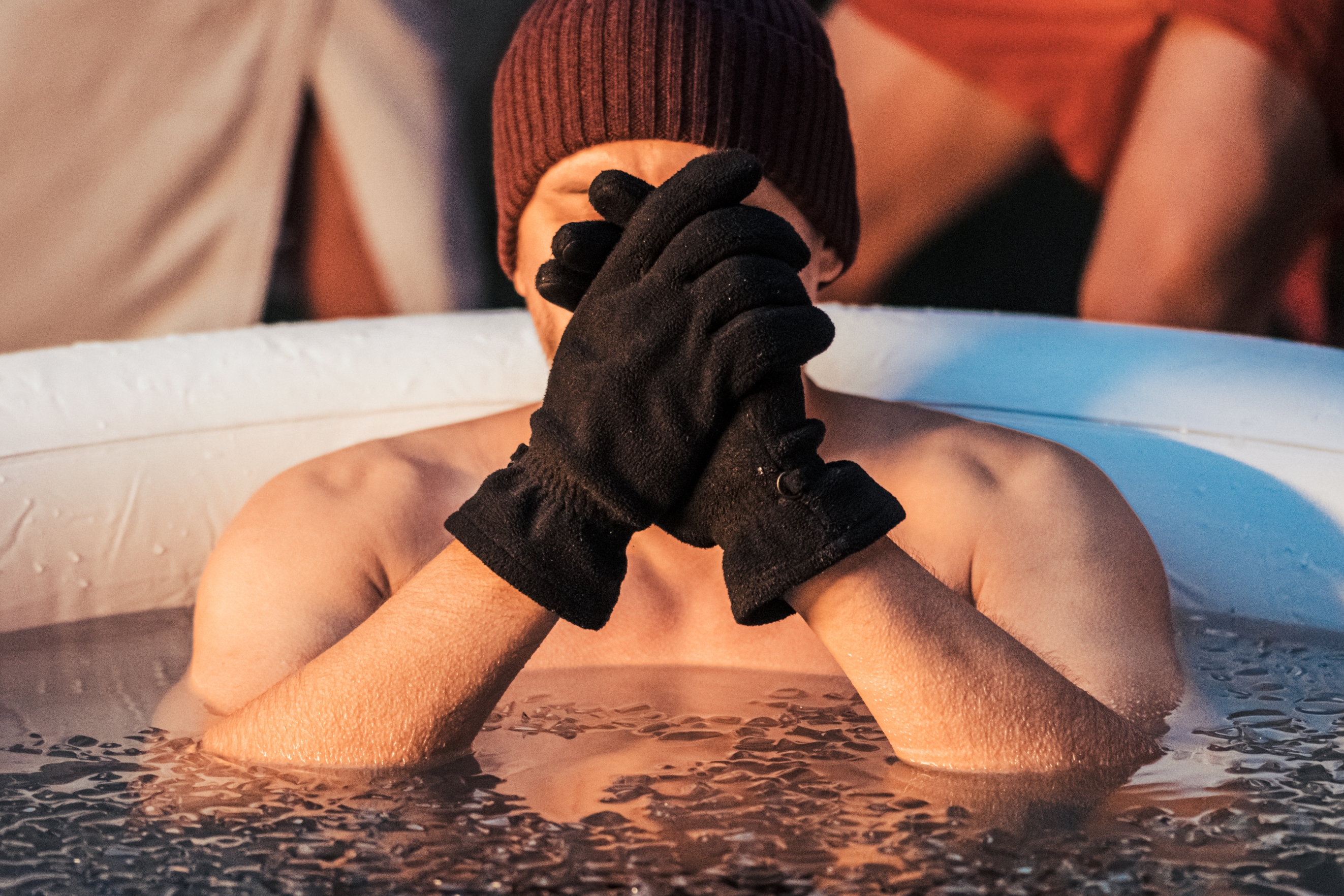 A chilly man in an inflatable pool