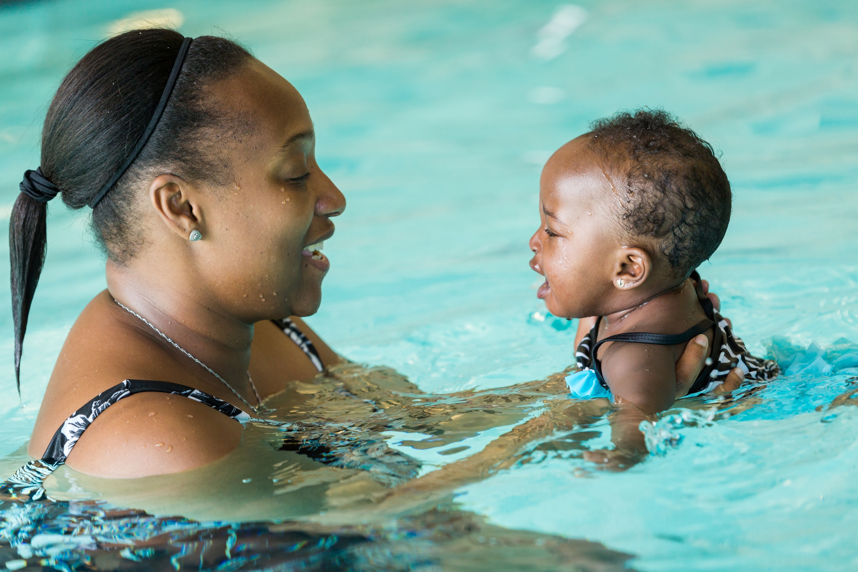 A woman and baby enjoying the pool