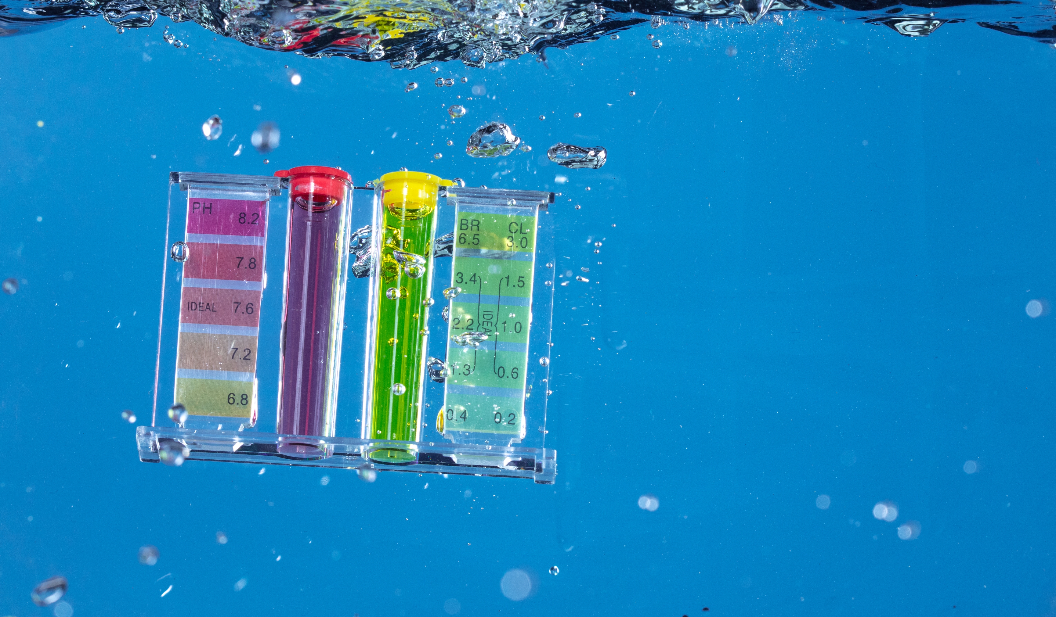 A pool testing kit floating in a pool
