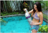 Girl Holding Telsa™ Cordless & Rechargeable Pool & Spa Cleaner