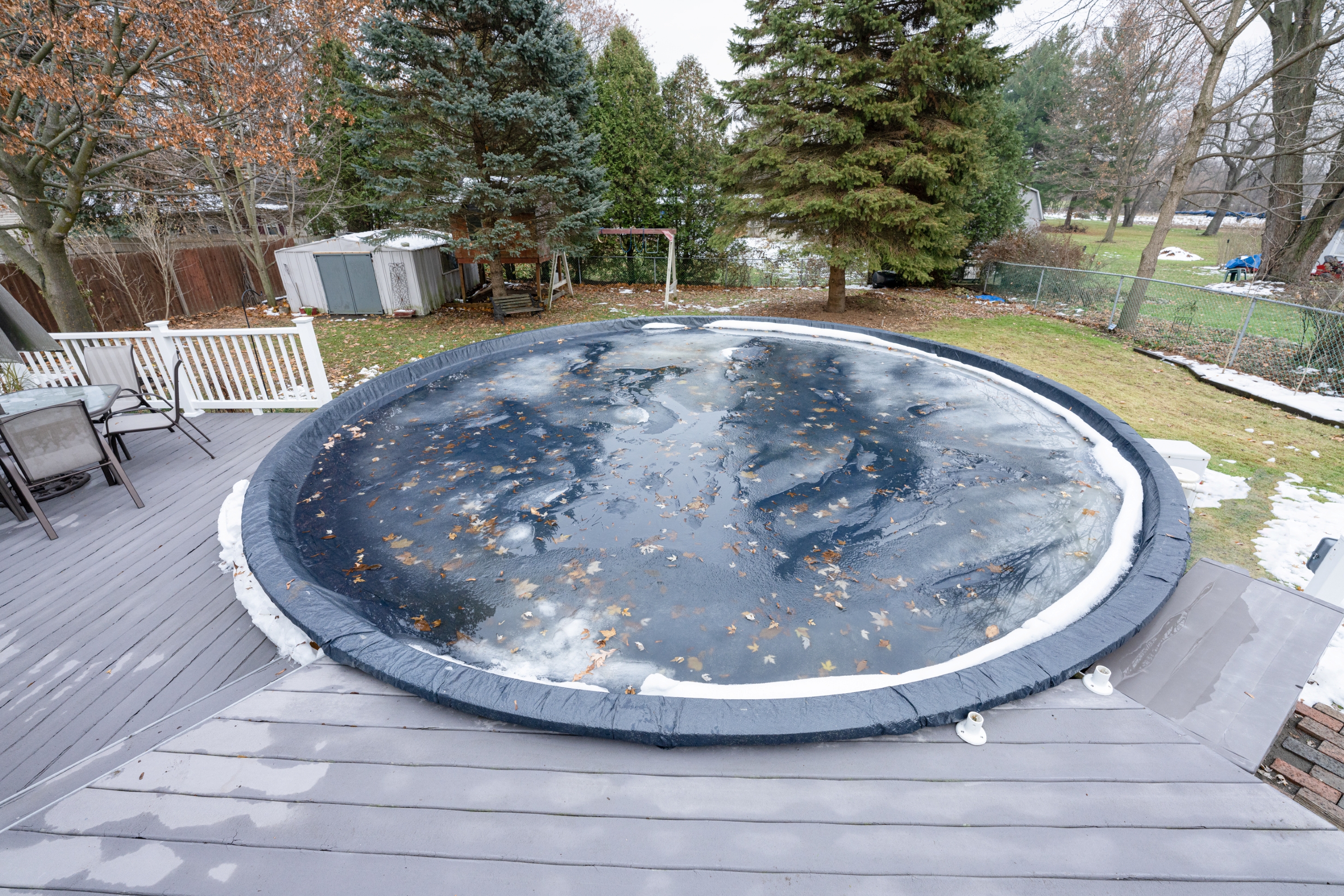 A closed above ground pool in the winter