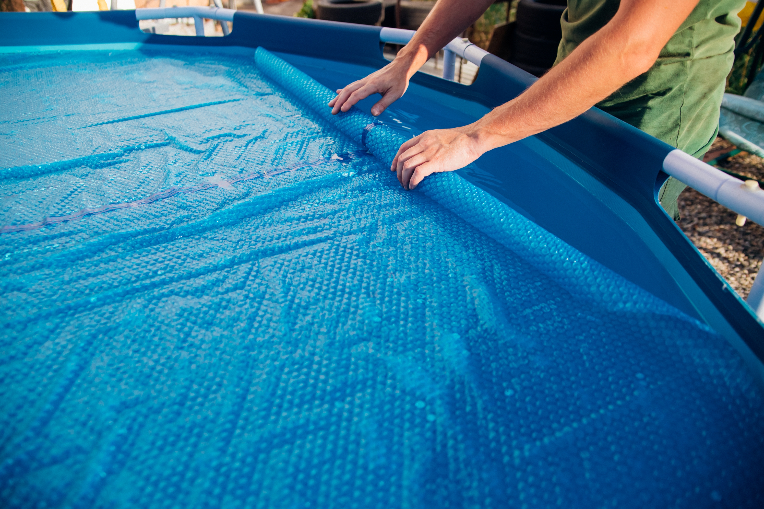 Covering a pool with a solar cover