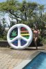 Woman Holding Up Peace Mon' Island Inflatable Pool Float