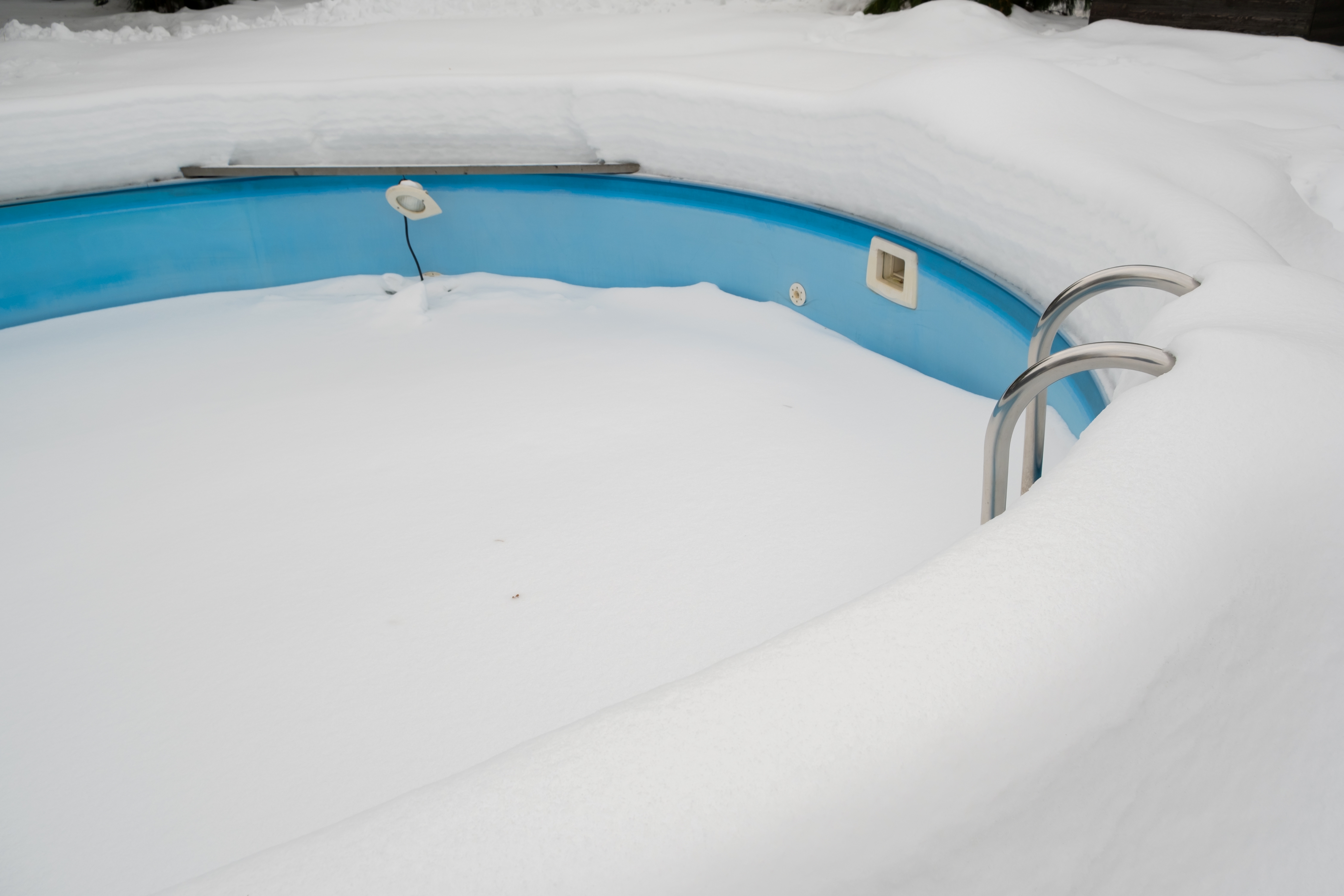 A pool full of snow in the winter